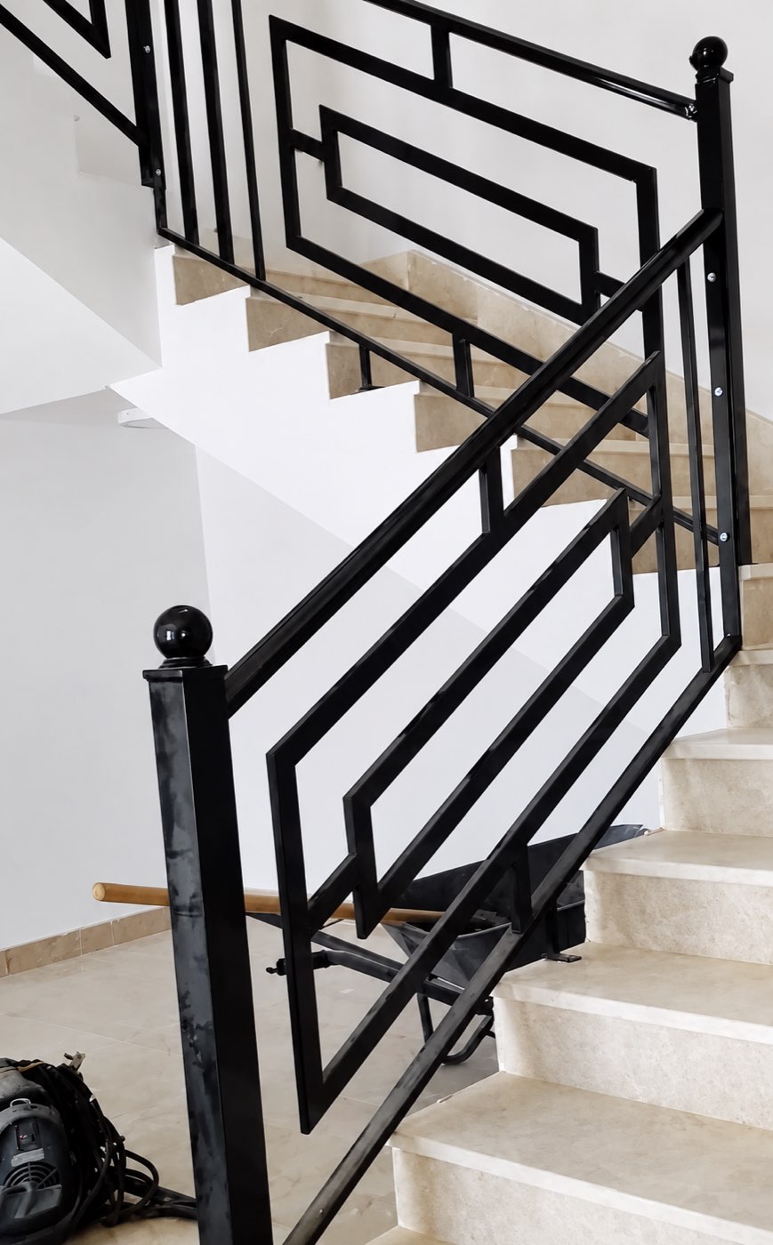 Stone stairs with black handrail