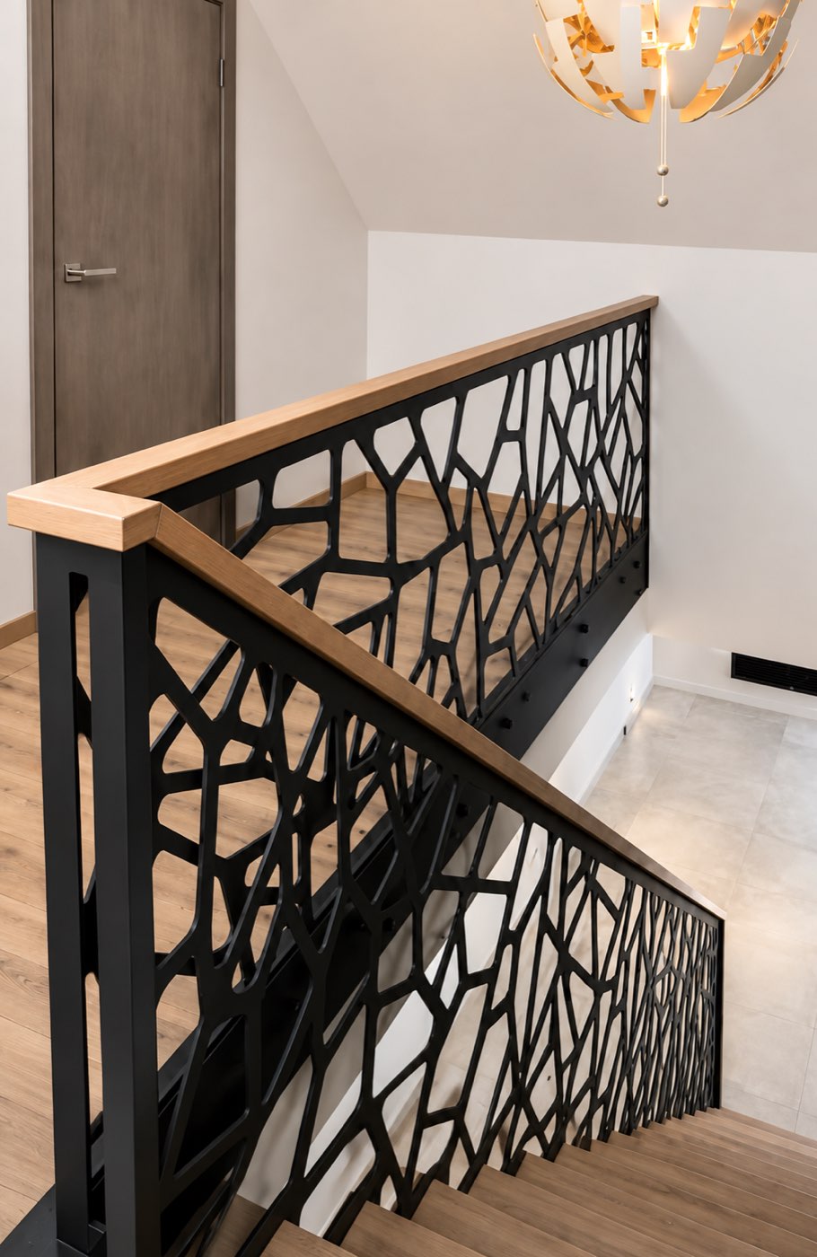 Villa staircase with a steel railing and timber handrail installed by Fahad Shafiq Trading